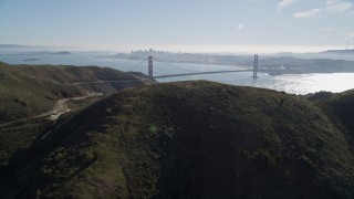 AXSF05_045 - 5K aerial stock footage flyby the Marin Headlands, eclipsing Golden Gate Bridge, San Francisco skyline in background, Marin County, California