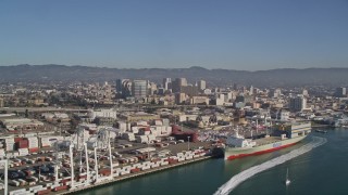 AXSF05_084 - 5K aerial stock footage flying by Port of Oakland Inner Harbor, Downtown Oakland in the background, California