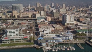 AXSF05_085 - 5K aerial stock footage of flying by Jack London Square and office buildings, Oakland, California