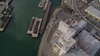 AXSF06_003 - 5K aerial stock footage of waterfront warehouses and factories, reveal Union Point Park, Oakland Estuary, California