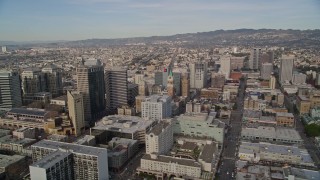 AXSF06_006 - 5K aerial stock footage of tilting from the freeway to reveal office buildings, city hall, I-980 in Downtown Oakland, California