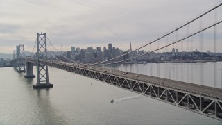 AXSF06_013 - 5K aerial stock footage track light Bay Bridge traffic with views of the skyline, San Francisco, California