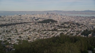AXSF06_037 - 5K aerial stock footage tilt from hillside homes and Mount Sutro forest to reveal skyscrapers in Downtown San Francisco, California