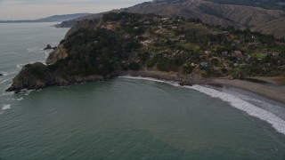 AXSF06_051 - 5K aerial stock footage of flying by hillside homes on coastal cliffs in Muir Beach, Marin County, California
