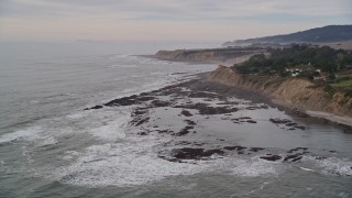 AXSF06_058 - 5K aerial stock footage of flying by ocean waves near coastal cliffs, Bolinas, California
