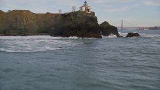 AXSF06_075 - 5K aerial stock footage fly over the Point Bonita Lighthouse revealing Golden Gate Bridge, San Francisco, California