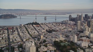 AXSF06_080 - 5K aerial stock footage approach Coit Tower, Bay Bridge, pan to skyscrapers in Downtown San Francisco, California