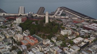 AXSF06_083 - 5K aerial stock footage tilt from North Beach apartments, reveal Coit Tower and piers, San Francisco, California