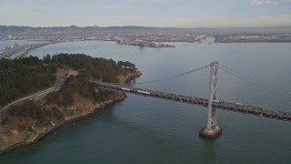 AXSF06_087 - 5K aerial stock footage approach the Bay Bridge and tilt to reveal Coast Guard Station on Yerba Buena Island, San Francisco, California