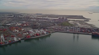 AXSF06_090 - 5K aerial stock footage of flying by the Port of Oakland, California