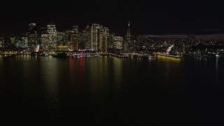AXSF07_006 - 5K aerial stock footage of the city skyline at night seen from the bay, Downtown San Francisco, California, night