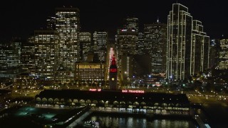 AXSF07_007 - 5K aerial stock footage tilt to reveal and ascend over Ferry Building, Downtown San Francisco skyscrapers, and Market Street, California, night