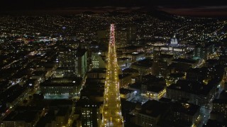 AXSF07_009 - 5K aerial stock footage of flying over Market Street through Civic Center near city hall, San Francisco, California, night