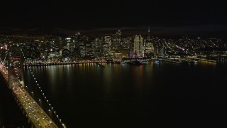 AXSF07_014 - 5K aerial stock footage fly away from the Downtown San Francisco skyline, revealing Bay Bridge, California, night