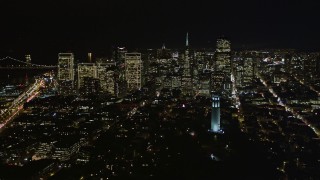 AXSF07_024 - 5K aerial stock footage orbit Coit Tower, to reveal skyscrapers in Downtown San Francisco, California, night