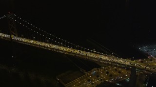 AXSF07_027 - 5K aerial stock footage approach and pan across heavy Bay Bridge traffic, Downtown San Francisco, California, night