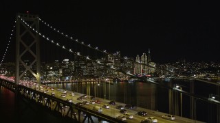 AXSF07_032 - 5K aerial stock footage focus on Downtown San Francisco skyline and fly over Bay Bridge, California, night