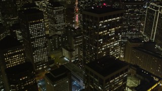 AXSF07_034 - 5K aerial stock footage tilt from The Embarcadero, reveal Downtown San Francisco skyscrapers, California, night