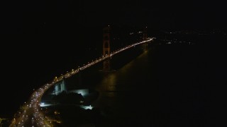 AXSF07_038 - 5K aerial stock footage tilt from bird's eye of freeway interchange to reveal Golden Gate Bridge, San Francisco, California, night