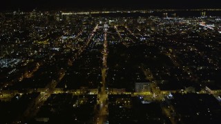 AXSF07_054 - 5K aerial stock footage of following Fulton Street, tilt to reveal city hall, Western Addition, San Francisco, California, night