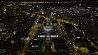 AXSF07_056 - 5K aerial stock footage fly over Fulton Street, tilt to reveal city hall in Civic Center, tilt to bird's eye view view, San Francisco, California, night