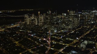 AXSF07_064 - 5K aerial stock footage of tilting from Columbus Ave to reveal skyscrapers in Downtown San Francisco, California, night