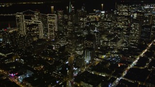AXSF07_065 - 5K aerial stock footage tilt up Columbus Avenue to reveal Transamerica Pyramid and skyscrapers, Downtown San Francisco, California, night