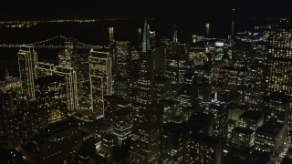 AXSF07_066 - 5K aerial stock footage of tilting from Columbus Ave to reveal skyscrapers in Downtown San Francisco, California, night