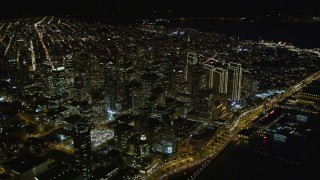 AXSF07_069 - 5K aerial stock footage orbit Infinity Towers condominiums, tilt to reveal Downtown San Francisco, California, night