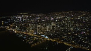 AXSF07_071 - 5K aerial stock footage high altitude view of Downtown San Francisco, California, seen from San Francisco Bay at night