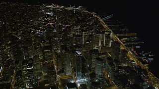 AXSF07_076 - 5K aerial stock footage tilt from The Embarcadero to reveal I-80 and Downtown San Francisco, California, night