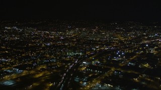 AXSF07_089 - 5K aerial stock footage fly over I-880, tilt revealing Downtown Oakland, California, night