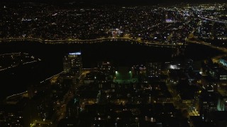 AXSF07_091 - 5K aerial stock footage flying over high-rises toward Lake Merritt, Downtown Oakland, California, night