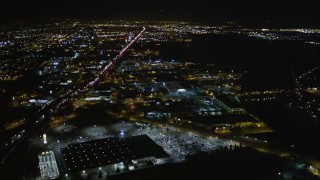 AXSF07_097 - 5K aerial stock footage of flying over I-880 freeway and warehouses, Oakland, California, night