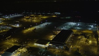 AXSF07_101 - 5K aerial stock footage fly by FedEx terminal, Oakland International Airport, Oakland, California, night