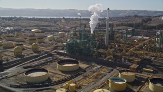 AXSF08_035 - 5K aerial stock footage of flying by Valero Oil Refinery buildings, Benicia, California