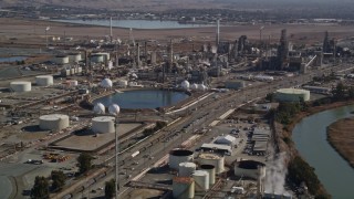 AXSF08_055 - 5K aerial stock footage of flying by oil refinery buildings at Tesoro Golden Eagle Refinery, Pacheco, California