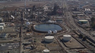 AXSF08_056 - 5K aerial stock footage of flying by pond at Tesoro Golden Eagle Refinery, Pacheco, California