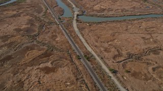 AXSF08_058 - 5K aerial stock footage of a reverse view of train tracks and Waterfront Road, Martinez, California