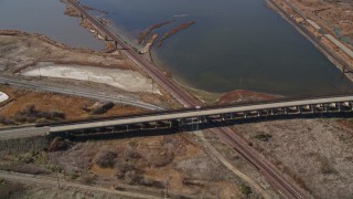 AXSF08_059 - 5K aerial stock footage of flying away from railroad tracks, marshlands, Martinez, California