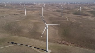 AXSF08_065 - 5K aerial stock footage tilt from small hills, reveal Shiloh Wind Power Plant windmills, Montezuma Hills, California