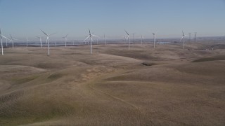 AXSF08_066 - 5K aerial stock footage of tilting from brown hills revealing Shiloh Wind Power Plant, Montezuma Hills, California