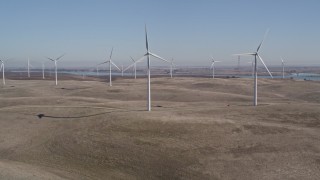 AXSF08_067 - 5K aerial stock footage tilt from hills to reveal Shiloh Wind Power Plant windmills, Montezuma Hills, California
