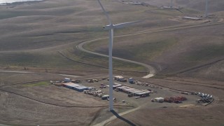 AXSF08_071 - 5K aerial stock footage of cargo containers and Shiloh Wind Power Plant windmill, Montezuma Hills, California
