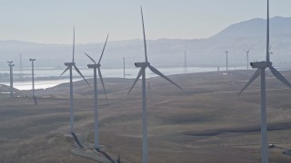 AXSF08_075 - 5K aerial stock footage of flying by a row of windmills, Shiloh Wind Power Plant, Montezuma Hills, California