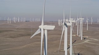 AXSF08_076 - 5K aerial stock footage orbit and pass by tops of windmills at Shiloh Wind Power Plant, Montezuma Hills, California