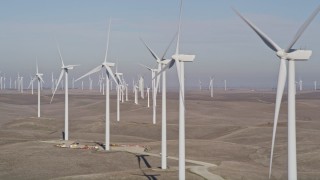 AXSF08_077 - 5K aerial stock footage of flying by a row of windmills, Shiloh Wind Power Plant, Montezuma Hills, California