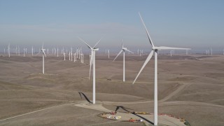 AXSF08_078 - 5K aerial stock footage flyby windmills while zooming out at Shiloh Wind Power Plant, Montezuma Hills, California