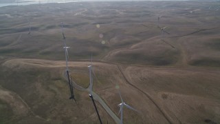AXSF08_079 - 5K aerial stock footage of flying by a row of windmills, Shiloh Wind Power Plant, Montezuma Hills, California