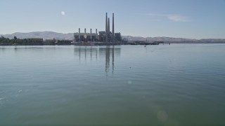 AXSF08_083 - 5K aerial stock footage tilt up from water, revealing Pittsburg power plant and smoke stacks, Pittsburg, California